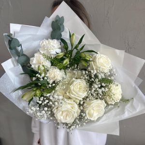 Luxurious white floral bouquet featuring roses, carnations, alstroemeria, baby’s breath and eucalyptus.